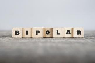 A stock photo with scrabble tiles arranged with the word BIPOLAR