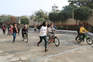 Down Syndrome Cycling Camp with kids learning to cycle and volunteers running along