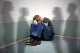 Image of a man in T shirt and jeans with schizophrenia hearing voices, hallucinating