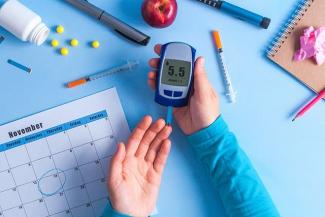 Diabetic with a glucometer in hand 