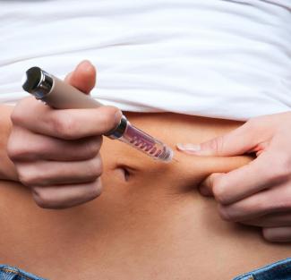 Diabetes patient jabbing themselves with insulin
