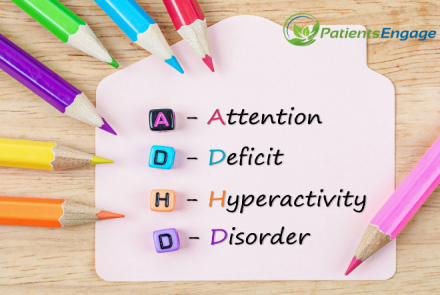 A post it with coloured pencils arranged around it and full form of ADHD - Attention Deficit Hyperactivity Disorder written on the post it