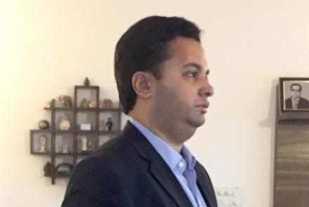 A young autistic man wearing a smart suit and tie