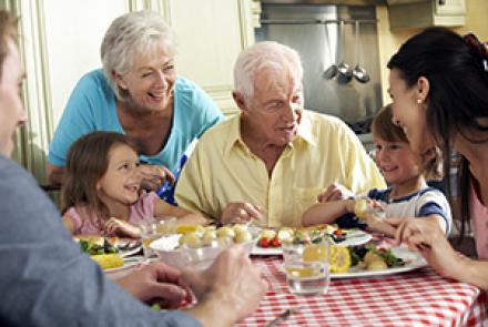 A family with three generations sitting around a dining table