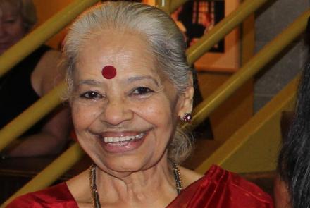 The author Dr Kalyani, a heart patient in a red sari and smiling 