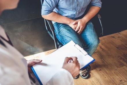 Stock pic of a man sitting with with his doctor