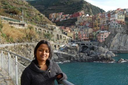 A young woman against a scenic backdrop of a lake and mountains