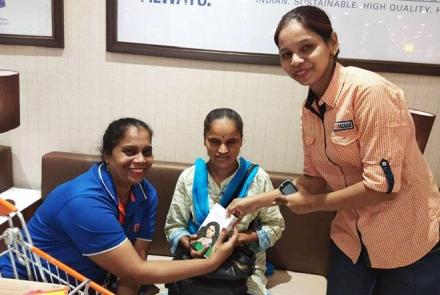 A shopping assistant helping a blind shopper with a braille shopping list