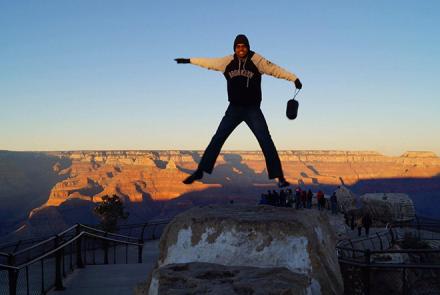 Peer Specialist with Psychosis Vijay jumping atop a canyon 