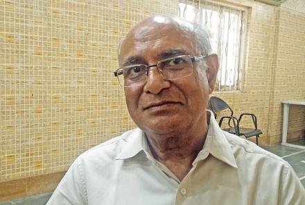 Image: Mr. Ramesh Thakkar who Has Parkinson's Disease with a spectacle framing his face and seated in a room